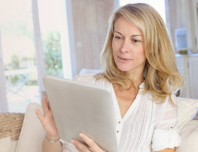 older woman using ipad for dating