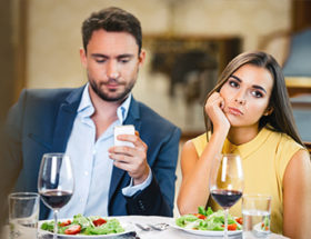 Man checking smartphone on date