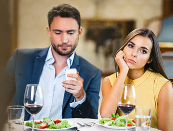 Man checking smartphone on date