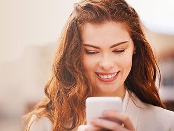 smiling woman looking at phone