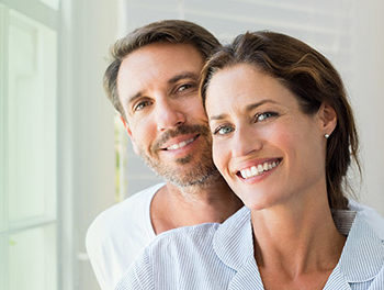 happy couple smiling on a green background