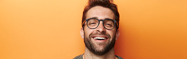 handsome bespectacled man laughing