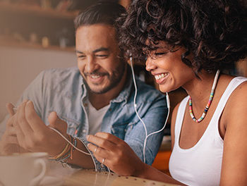 smiling couple listening to music