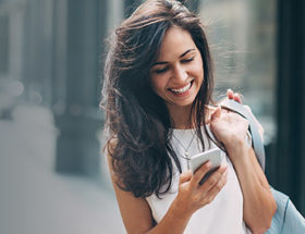 women smiling look at phone