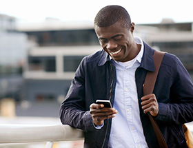 Handsome black man checking a text message