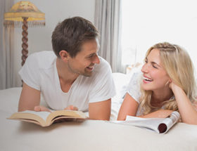 couple talking on a bed