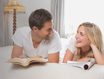 couple talking on a bed