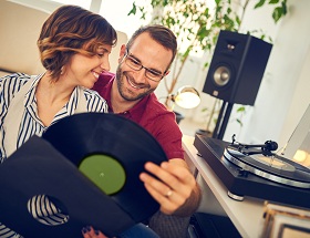 woman and man looking at records and hugging