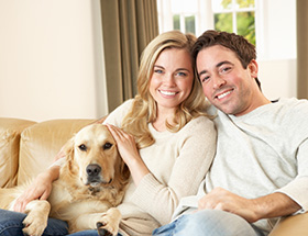 catholic couple with dog smiling