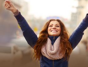 woman celebrating with hands up in the air