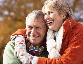 older couple hugging outside