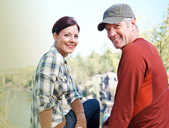 older couple smiling in a park