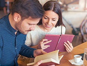 couple reading books in cafe
