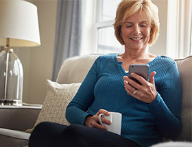 older woman on sofa looking at phone