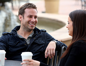 couple smiling drinking coffee
