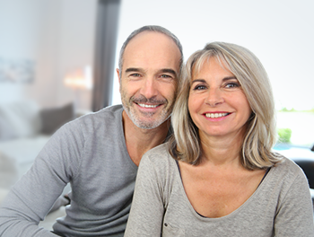 Couple sitting together grinning