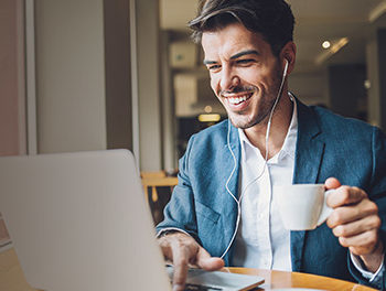 man smiling looking at laptop